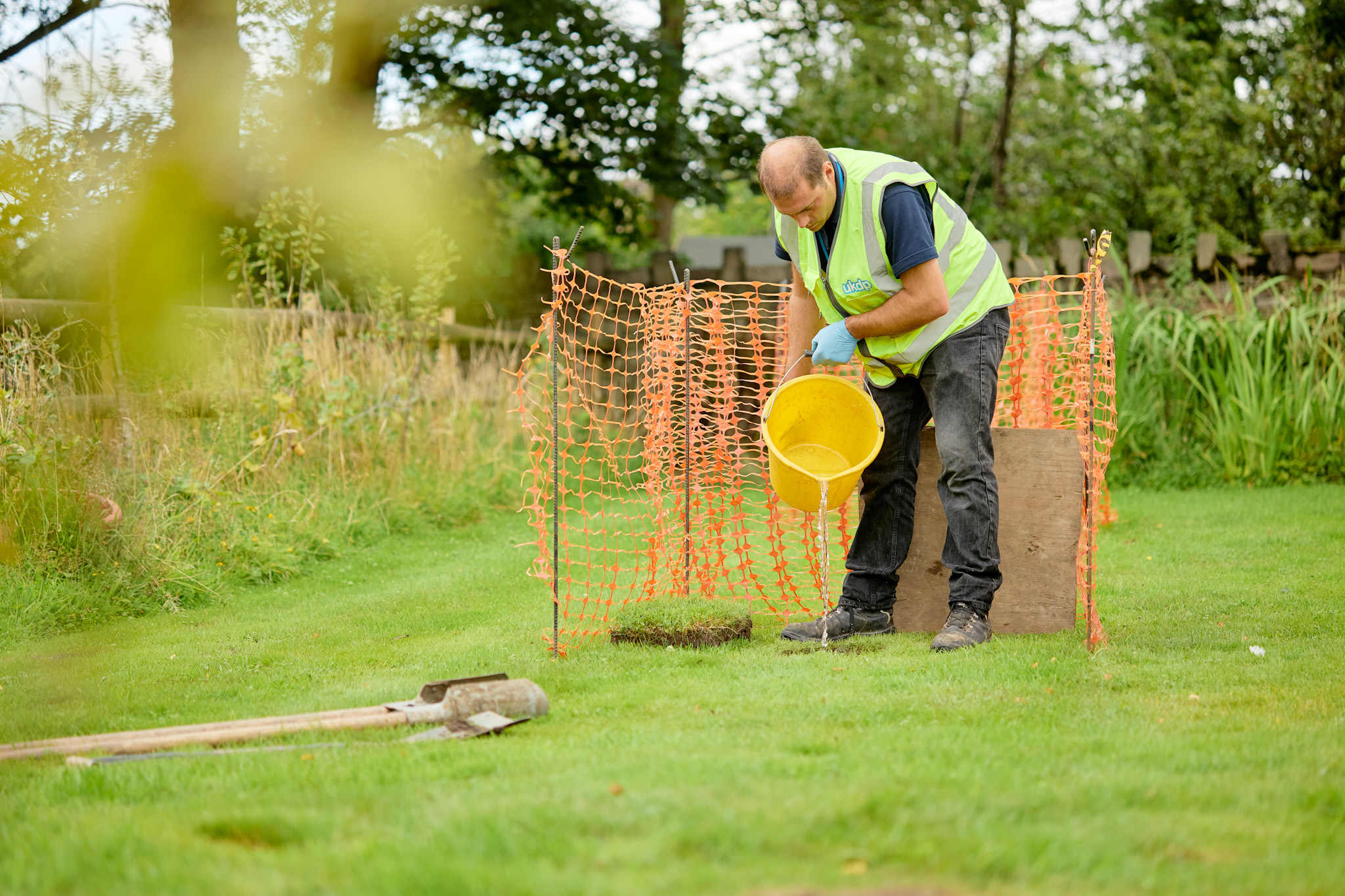 UKDP team member with bucket doing percolation test