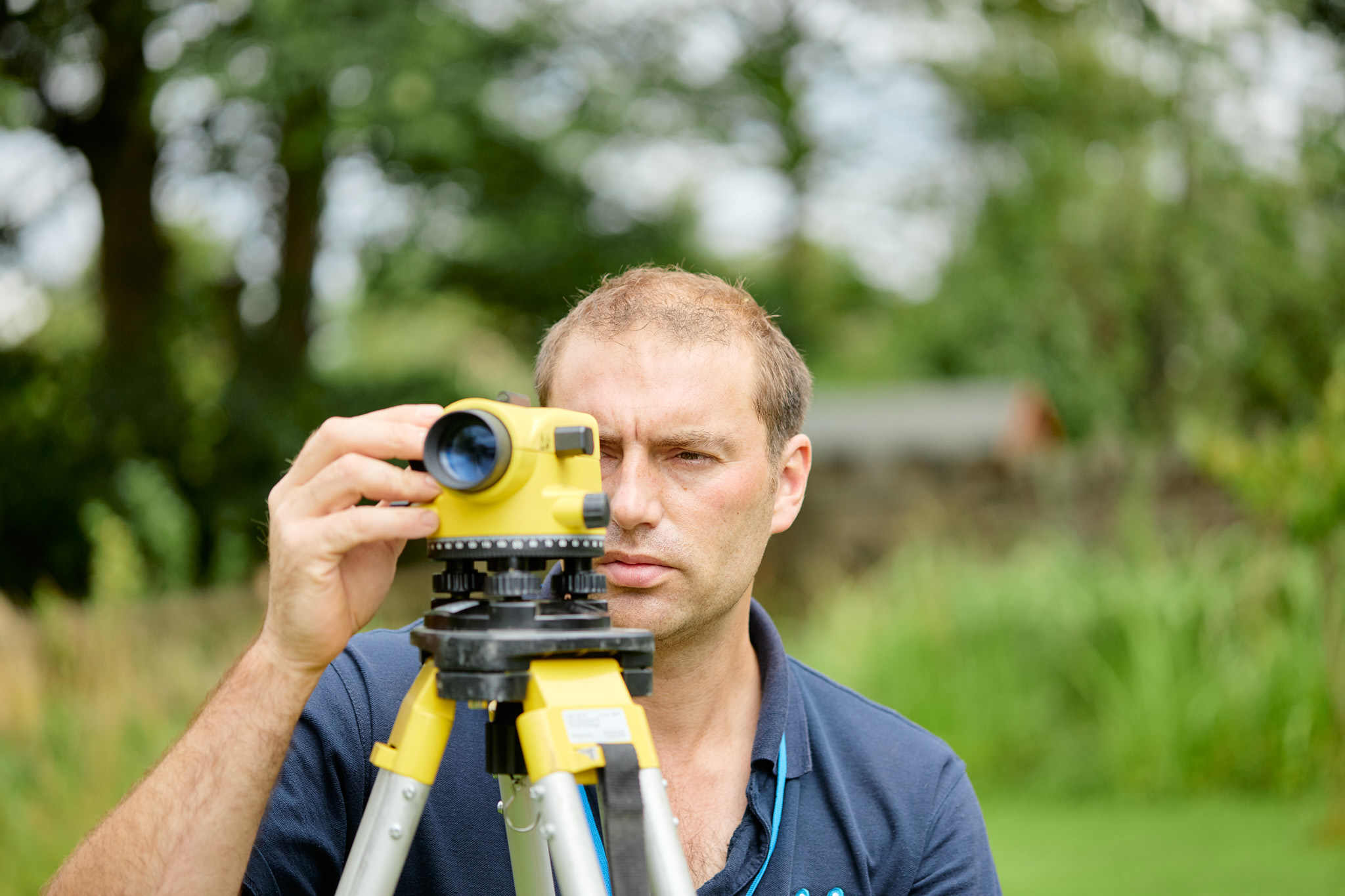 UKDP team member with drainage surveying measuring equipment
