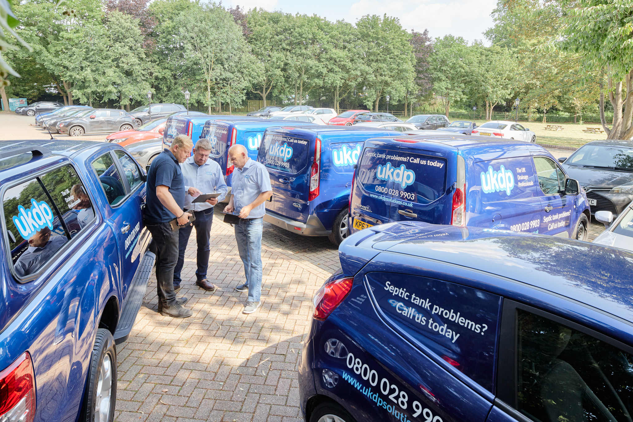 UKDP team with branded vehicle fleet